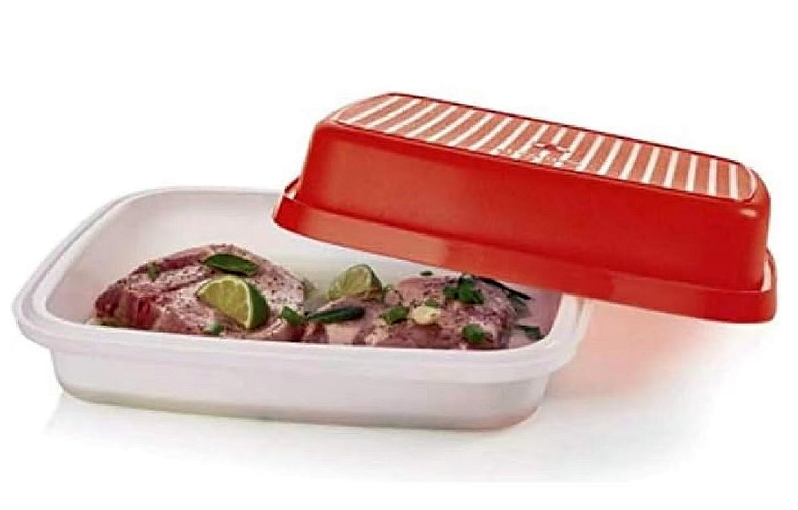 Practical kitchen favorites: White plastic food container with red lid, filled with lime and herb-marinated meat.