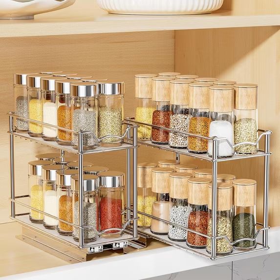 Practical kitchen favorites, these four metal racks keep glass spice jars organized on a wooden kitchen shelf.