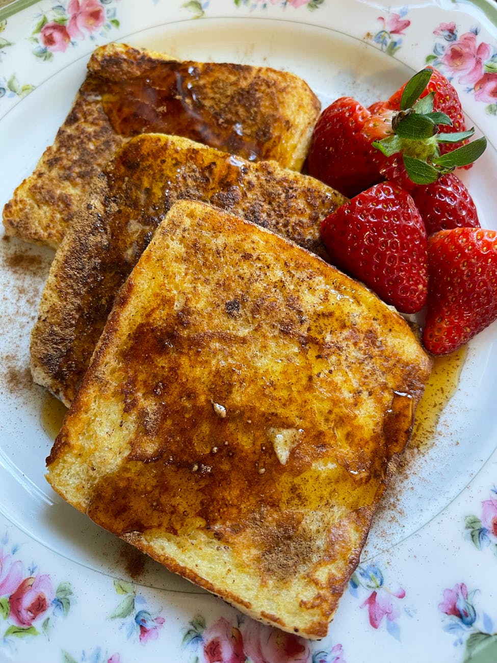 close up french toast with strawberries on the side