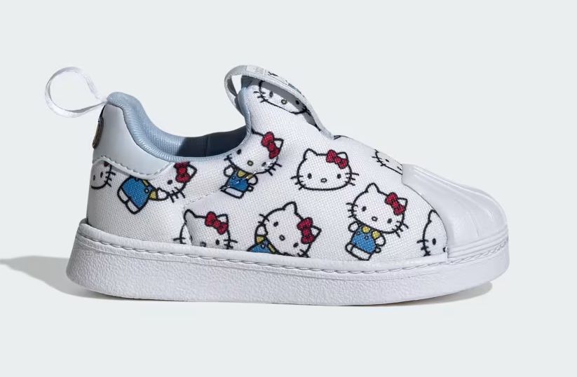 Adorable adidas toddler shoes with Hello Kitty faces, blue overalls, red bows, and a comfy white rubber sole.
