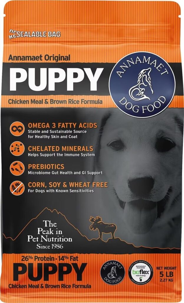 Annamaet Puppy dog food in an orange and black bag features a puppy’s face and highlights key benefits on the front.