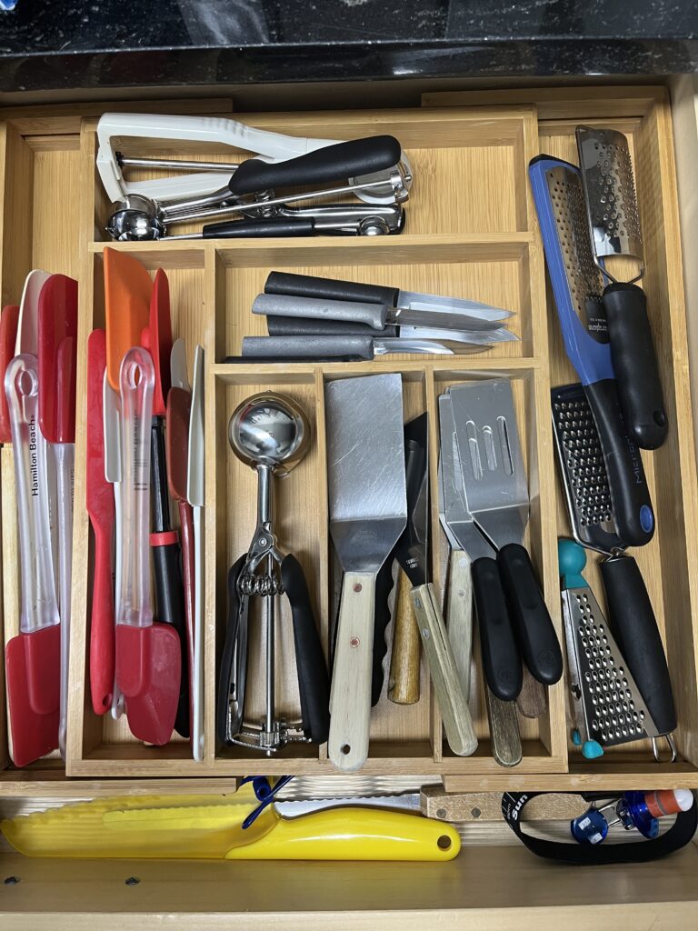 Drawer with neatly organized utensils—perfect to organize small kitchen tools like spatulas, graters, and knives.