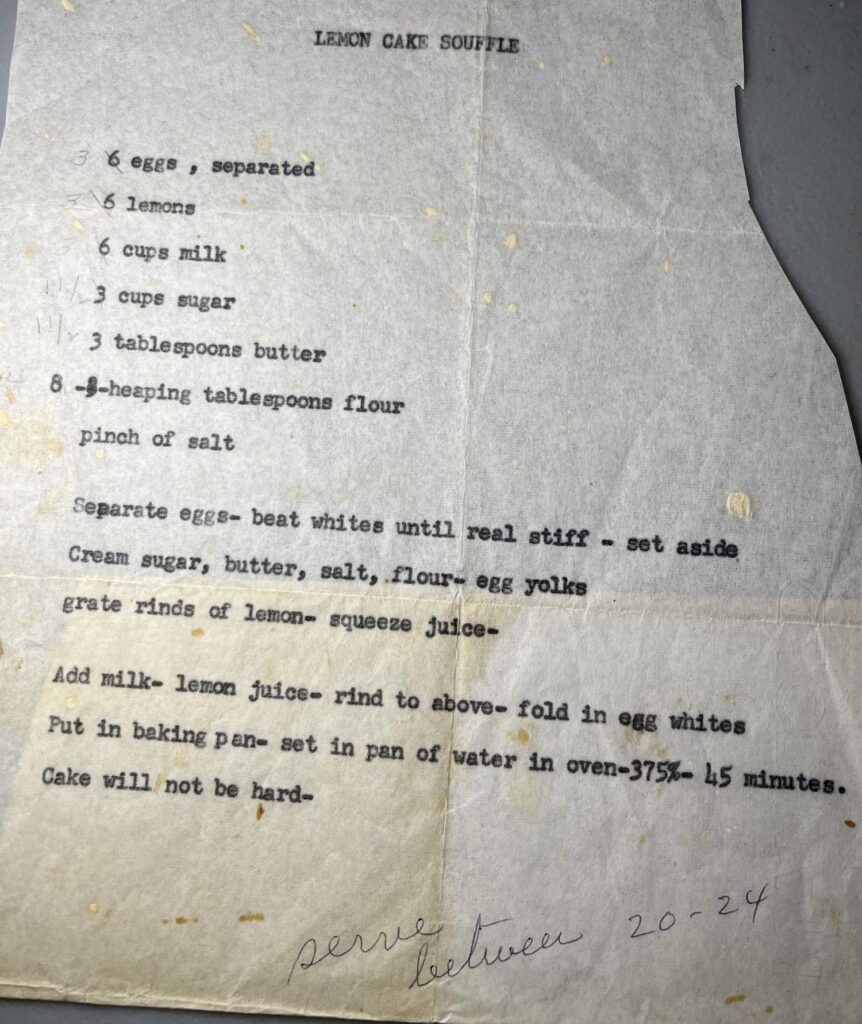 Typed Lunchroom Lemon Souffle cake recipe on aged paper, handwritten note: serve between 20-24 at the bottom.