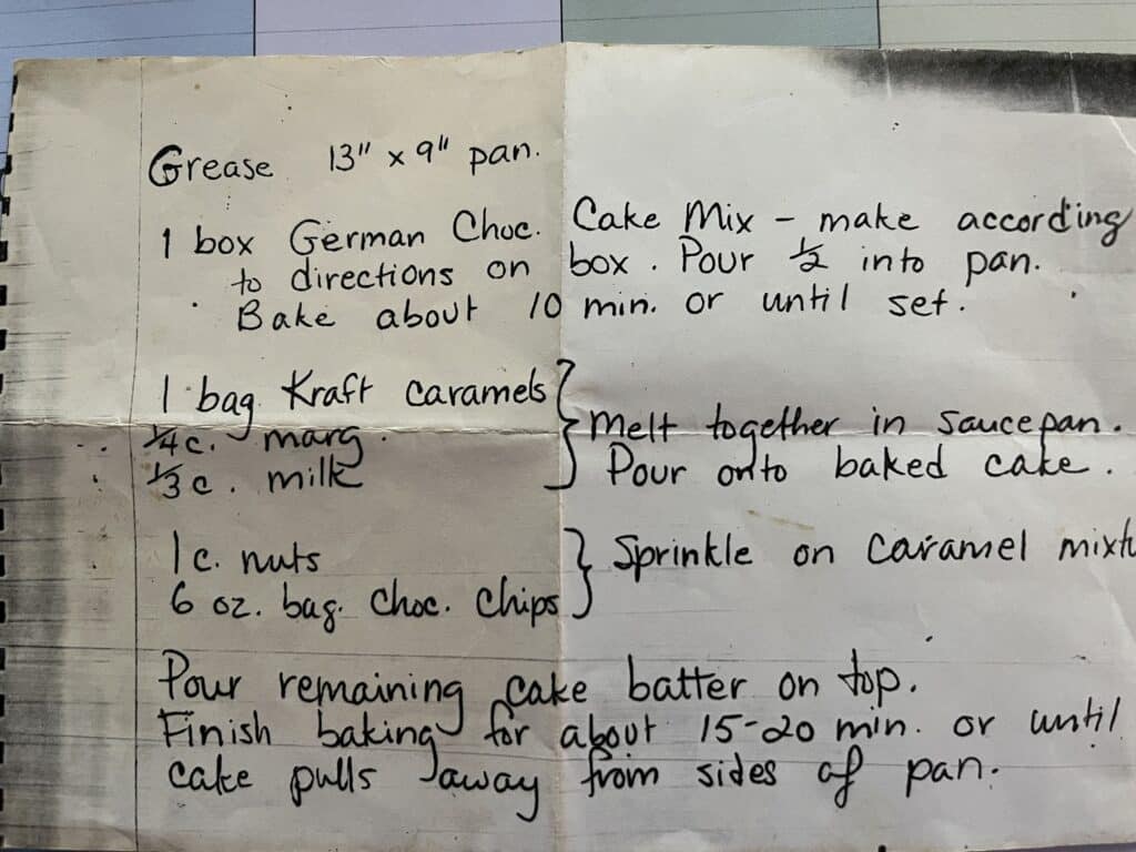 Handwritten recipe for Mom’s Gooey German Chocolate Cake, listing ingredients and baking steps on lined paper.