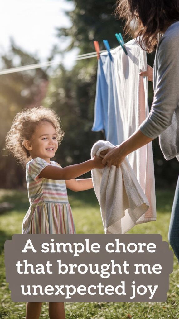 A smiling child helps an adult master The Art of Hanging Clothes on a Line, framed by sunlit grass in the background.