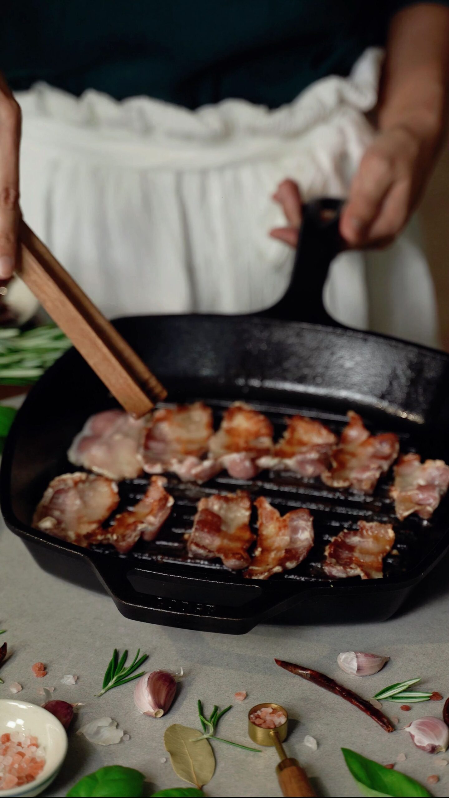 Bacon slices sizzling in a skillet